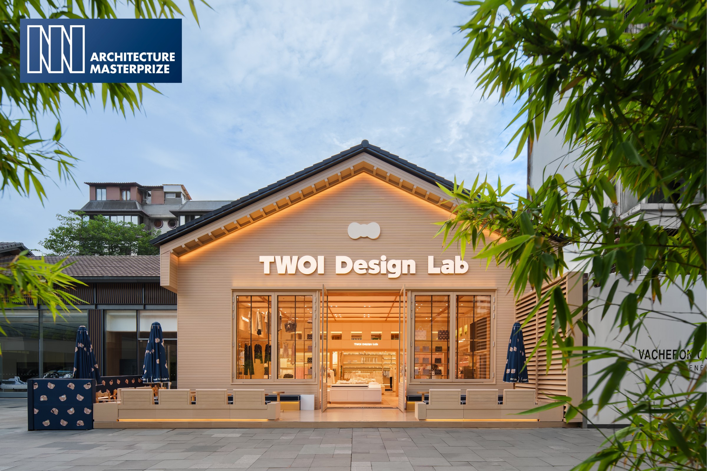 The street-facing facade and seating connect the store with city life.