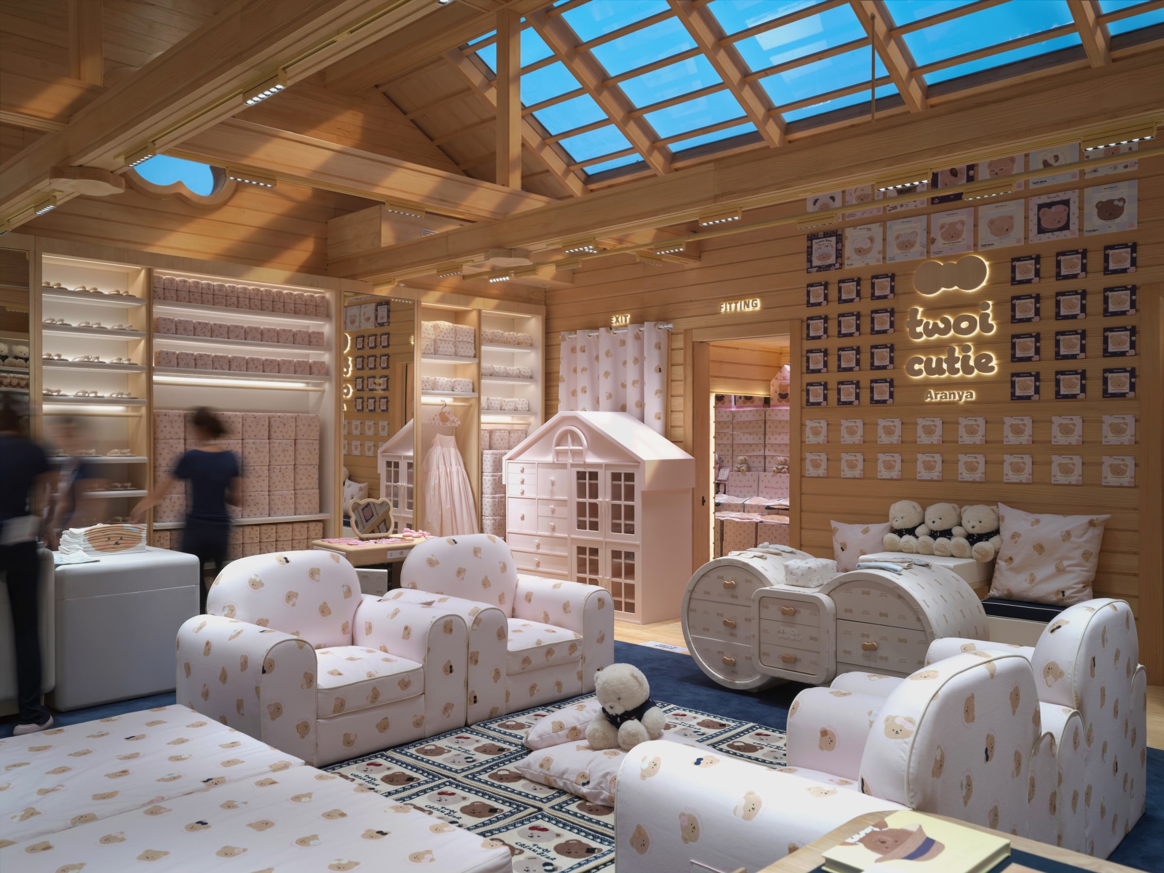 House of TWOI Aranya living room beneath timber beams and glazed rooflights